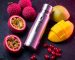 A premium disposable vape surrounded by exotic fruits like lychee and passionfruit.