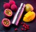 A premium disposable vape surrounded by exotic fruits like lychee and passionfruit.